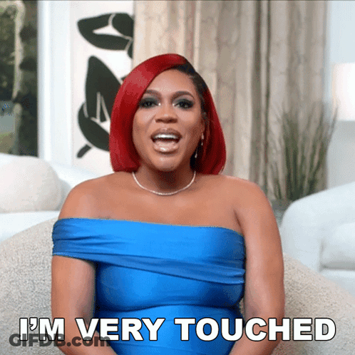 A Woman With Red Hair And A Blue Dress Says I 'M Very Touched GIF