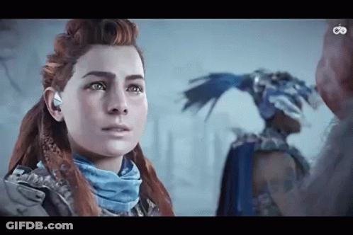 A Woman With Red Hair And A Blue Scarf Is Standing Next To A Man In A Blue Costume . GIF