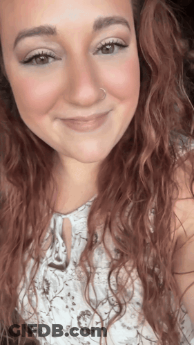 A Woman With Red Hair And A Nose Ring Smiles GIF