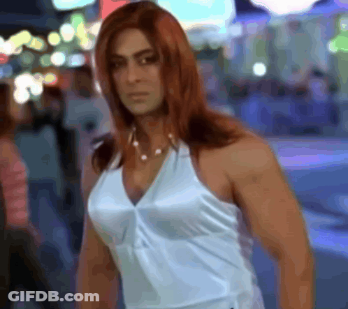 A Woman With Red Hair And A White Tank Top GIF