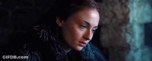 A Woman With Red Hair And Blue Eyes Is Wearing A Fur Coat . GIF