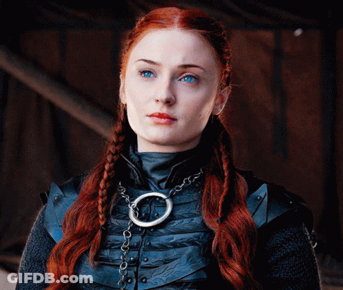 A Woman With Red Hair And Blue Eyes Is Wearing A Necklace GIF