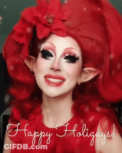 A Woman With Red Hair And Elf Ears Is Smiling With The Words Happy Holidays Below Her GIF