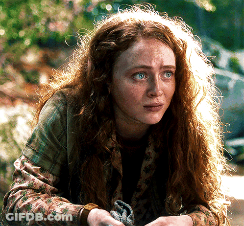 A Woman With Red Hair And Freckles Looks At The Camera With A Sad Look On Her Face GIF