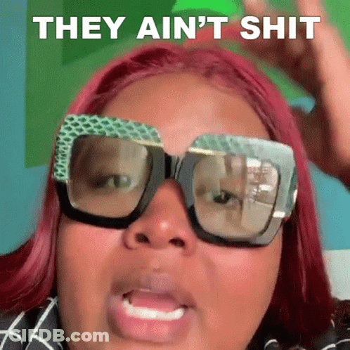 A Woman With Red Hair And Glasses Is Making A Funny Face And Saying They Ain 'T Shit . GIF