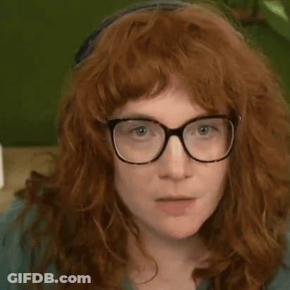A Woman With Red Hair And Glasses Is Pointing At The Camera With The Words " Do N't Let It Get To Your Head " Above Her GIF