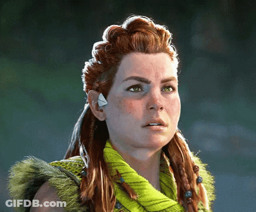A Woman With Red Hair And Green Eyes Is Wearing A Green Sweater GIF
