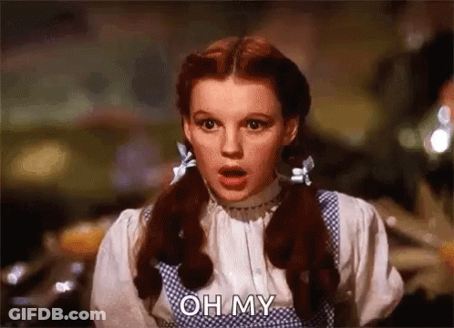 A Woman With Red Hair And Pigtails Is Making A Surprised Face And Saying Oh My . GIF