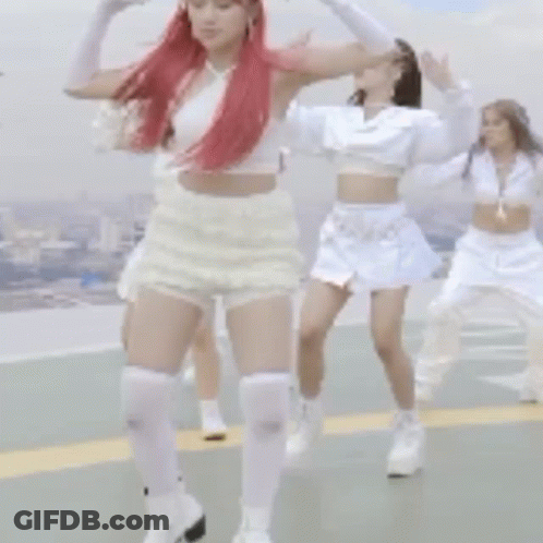 A Woman With Red Hair And White Shorts Is Dancing With Other Women GIF