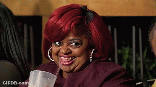 A Woman With Red Hair Drinking From A Plastic Cup With A Straw GIF