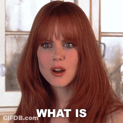A Woman With Red Hair Has The Words What Is Written On Her Face GIF