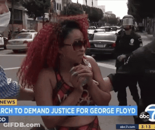 A Woman With Red Hair Is Being Interviewed By A Police Officer On Abc 7 News GIF