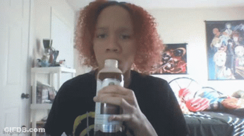 A Woman With Red Hair Is Drinking From A Bottle That Says Imgflip On It GIF