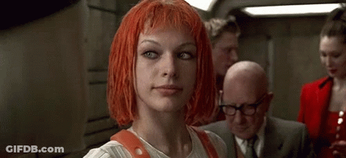 A Woman With Red Hair Is Holding A Badge And A Multipass . GIF