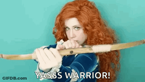 A Woman With Red Hair Is Holding A Bow And Arrow And Says Yasss Warrior ! GIF