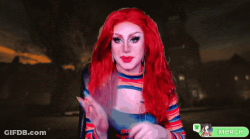 A Woman With Red Hair Is Holding A Knife In Front Of A Green Merch Button GIF