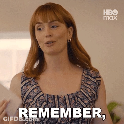 A Woman With Red Hair Is Holding A Piece Of Paper And Says " Remember " GIF