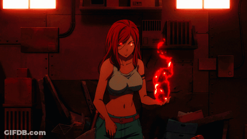 A Woman With Red Hair Is Holding A Red Object In Her Hand In A Dark Room GIF