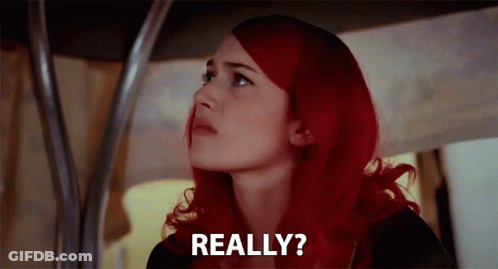 A Woman With Red Hair Is Looking Up And Says Really ? GIF