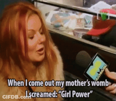 A Woman With Red Hair Is Screaming Into A Microphone While Holding A Card That Says " Girl Power " GIF
