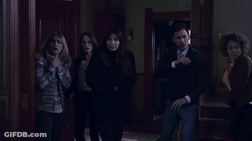 A Woman With Red Hair Is Screaming While Another Woman Stands Behind Her GIF