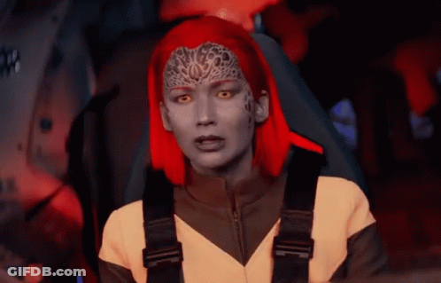 A Woman With Red Hair Is Sitting In A Car GIF