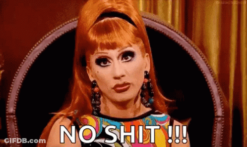 A Woman With Red Hair Is Sitting In A Chair And Saying `` No Shit !!! '' . GIF