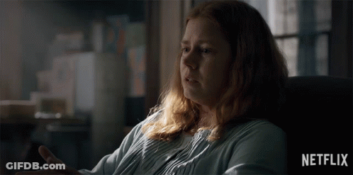 A Woman With Red Hair Is Sitting In A Chair With A Netflix Logo In The Corner GIF