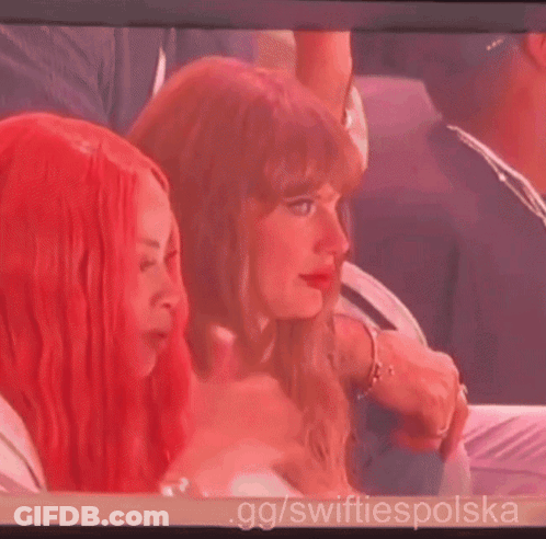 A Woman With Red Hair Is Sitting Next To Another Woman On A Screen With Gg / Swiftiespolska Written On It GIF