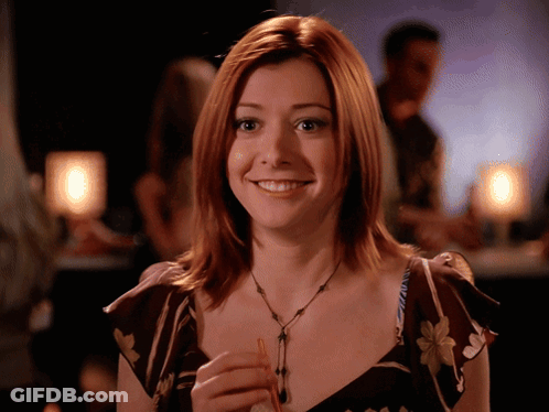 Red Haired Woman Smiling Holding Small Object GIF
