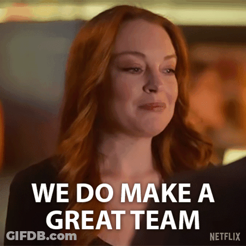 A Woman With Red Hair Is Smiling And Saying We Do Make A Great Team . GIF