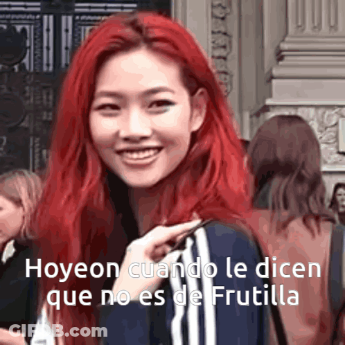 A Woman With Red Hair Is Smiling And Talking In Spanish GIF