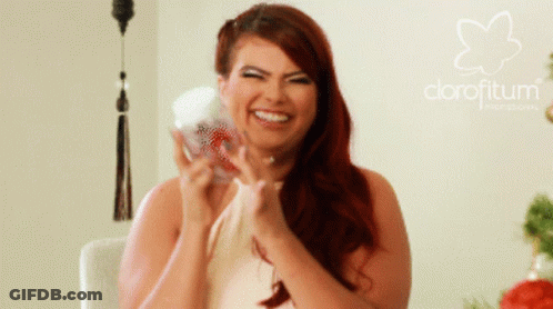 A Woman With Red Hair Is Smiling In Front Of A Logo For Clorofitum GIF