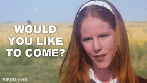 A Woman With Red Hair Is Standing In A Field With The Words " Would You Like To Come " Written Above Her GIF