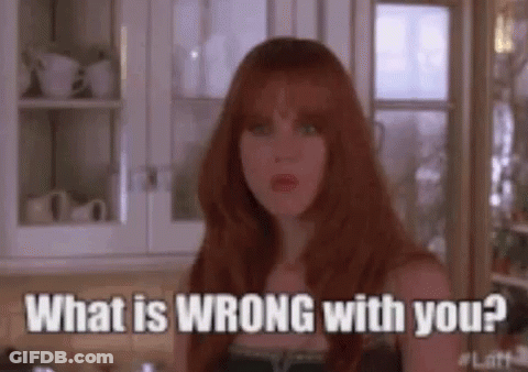 A Woman With Red Hair Is Standing In A Kitchen And Asking What Is Wrong With You ? GIF