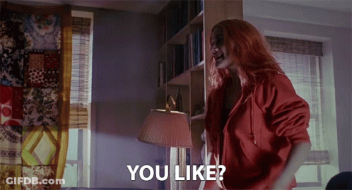 A Woman With Red Hair Is Standing In A Room With The Words " You Like " On The Bottom GIF