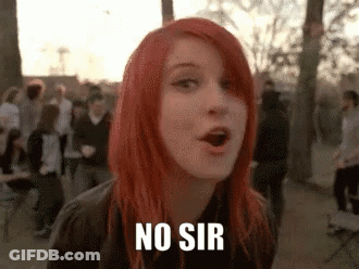 A Woman With Red Hair Is Standing In Front Of A Crowd And Says No Sir . GIF