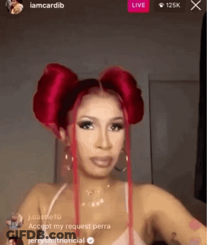 A Woman With Red Hair Is Standing In Front Of A Live Stream . GIF