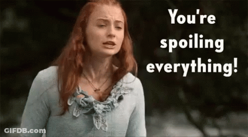 A Woman With Red Hair Is Standing In Front Of A Sign That Says " You 'Re Spoiling Everything " GIF