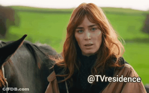 A Woman With Red Hair Is Standing Next To A Black Horse With The Words @Tvresidence Written Below Her GIF