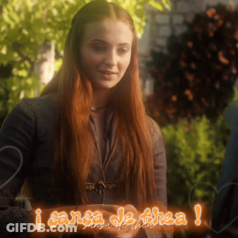 A Woman With Red Hair Is Standing Next To A Sign That Says I Sansa De Thea GIF