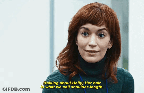 A Woman With Red Hair Is Talking About Helly Her Hair Is What We Call Shoulder - Length . GIF