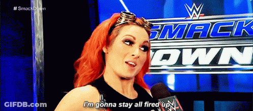 A Woman With Red Hair Is Talking Into A Microphone While Wearing Goggles . GIF
