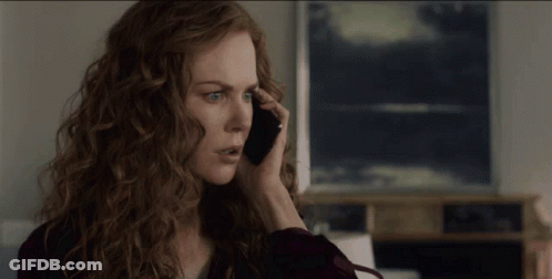 A Woman With Red Hair Is Talking On Her Cell Phone GIF