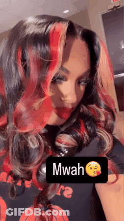 A Woman With Red Hair Is Wearing A Black Shirt With A Basketball On It GIF