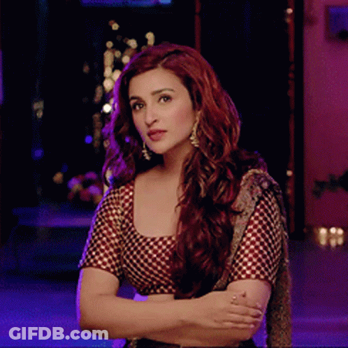 A Woman With Red Hair Is Wearing A Checkered Top GIF