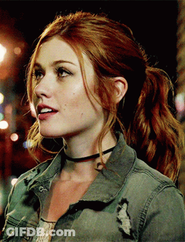 A Woman With Red Hair Is Wearing A Choker And A Ponytail GIF