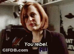 A Woman With Red Hair Is Wearing A Fbi Badge And Says You Rebel GIF