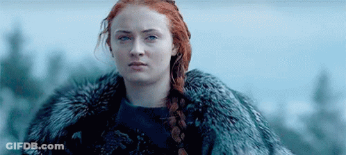 A Woman With Red Hair Is Wearing A Fur Coat And A Braid . GIF