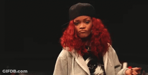 A Woman With Red Hair Is Wearing A Hat And A Hoodie And Giving The Middle Finger . GIF